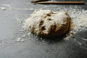 Dough and Flour on Grey Surface